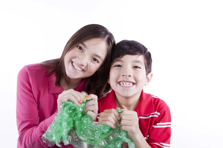 Kids holding christmas lights